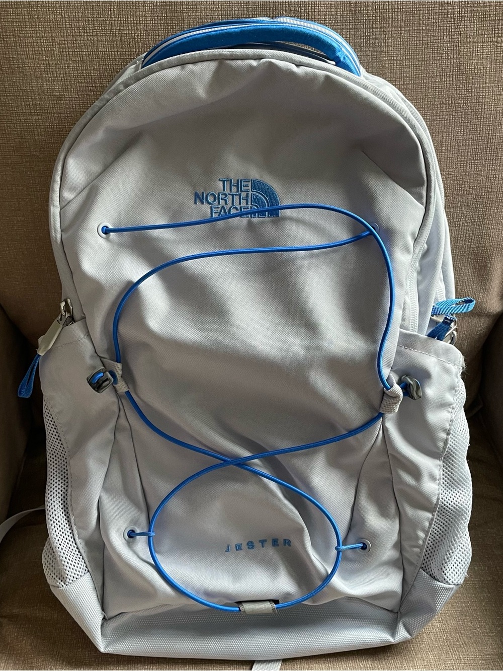 The North Face Light Gray Backpack with Blue Accents